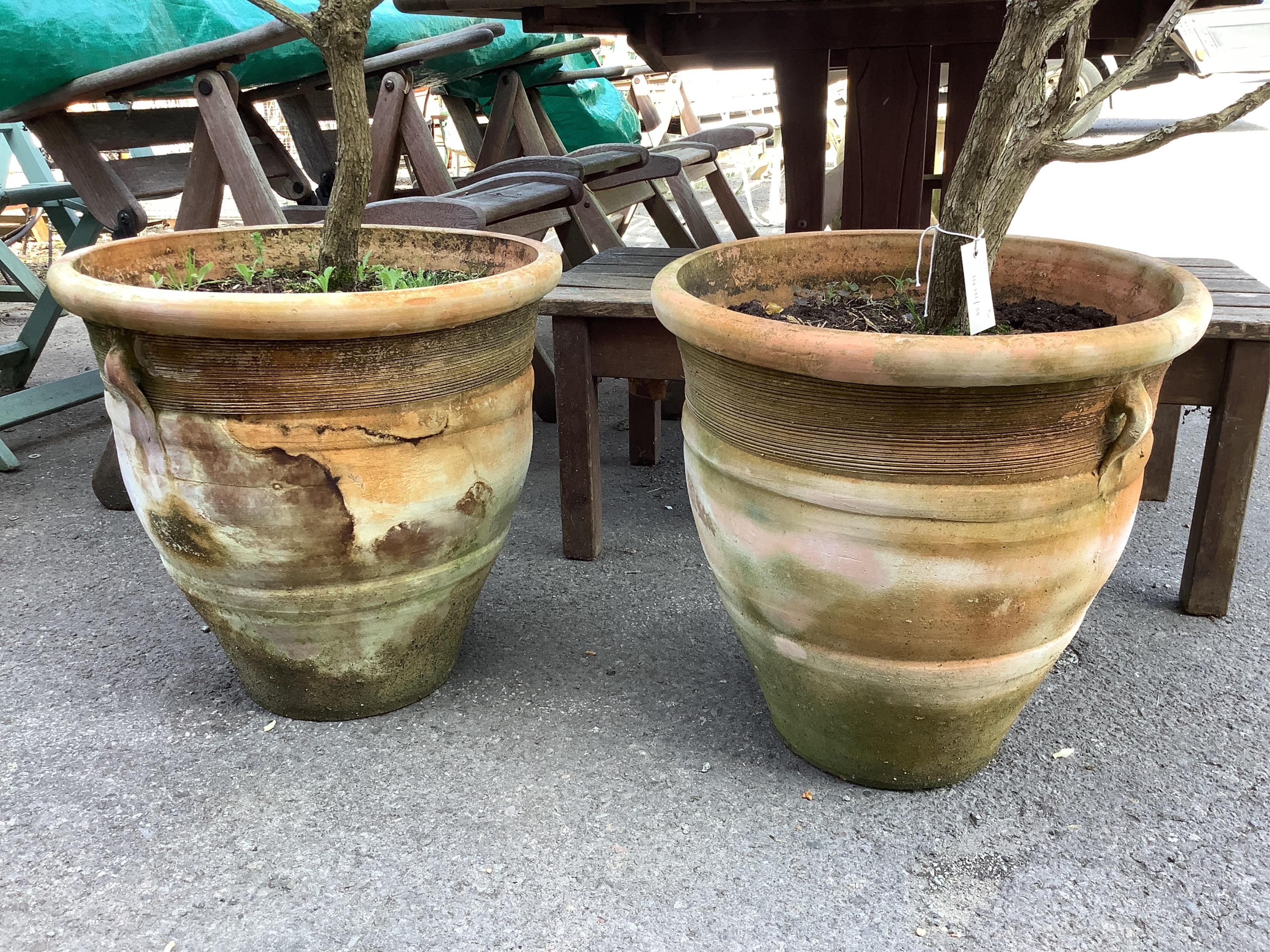 A pair of circular terracotta garden planters, diameter 46cm, height 45cm